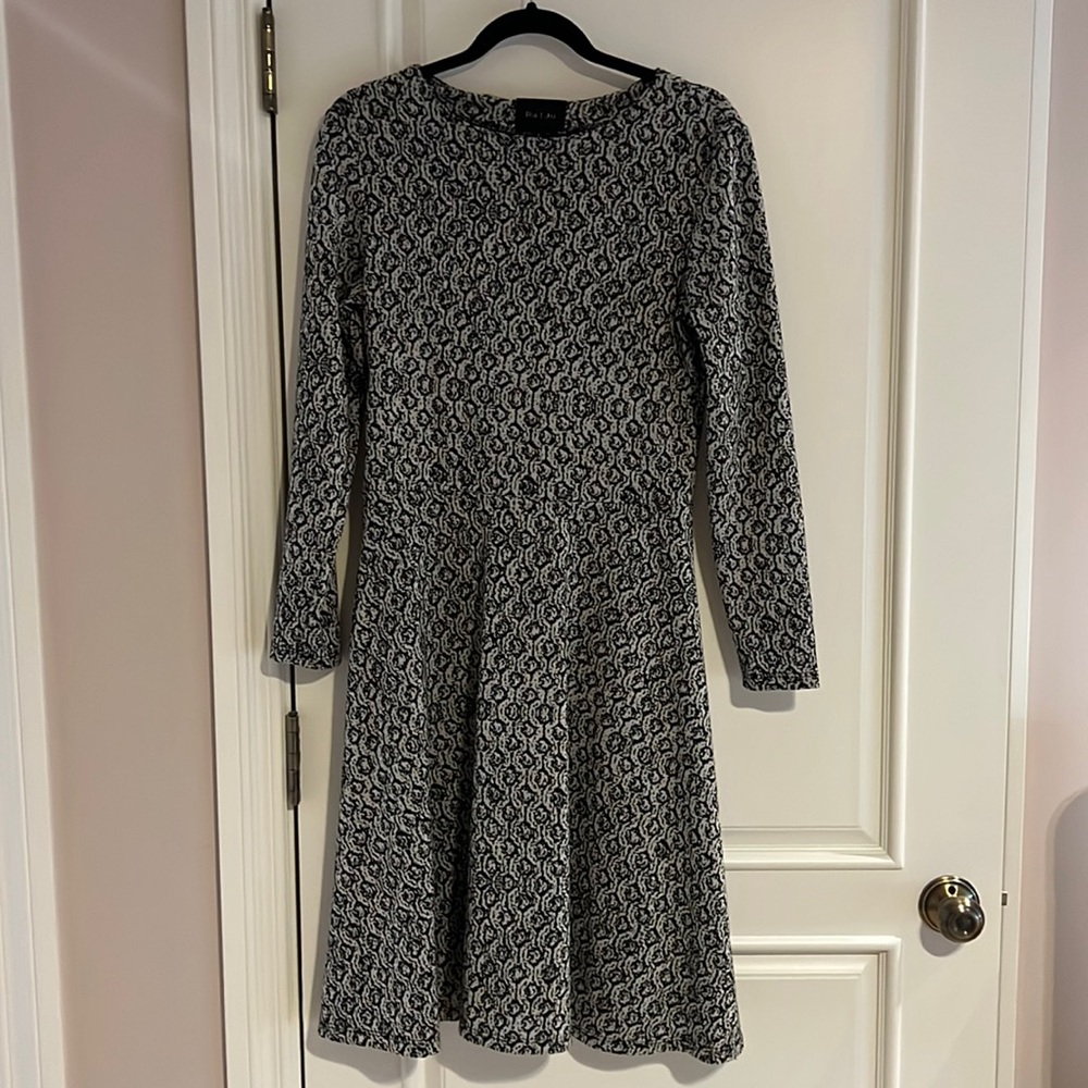 Black and beige skater style knit dress. Sleek design